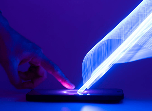 A finger touches a smartphone screen, emitting a swirling blue light trail upward, symbolizing technology and digital connectivity, all set against a dark purple background.