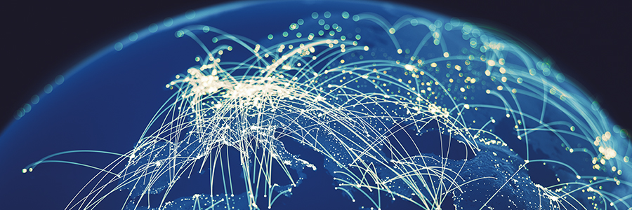 A digital rendering of Earth from space shows a network of glowing lines connecting various points across continents, symbolizing global communication. The blue background highlights the interconnected pathways, representing data transfer and international connectivity.