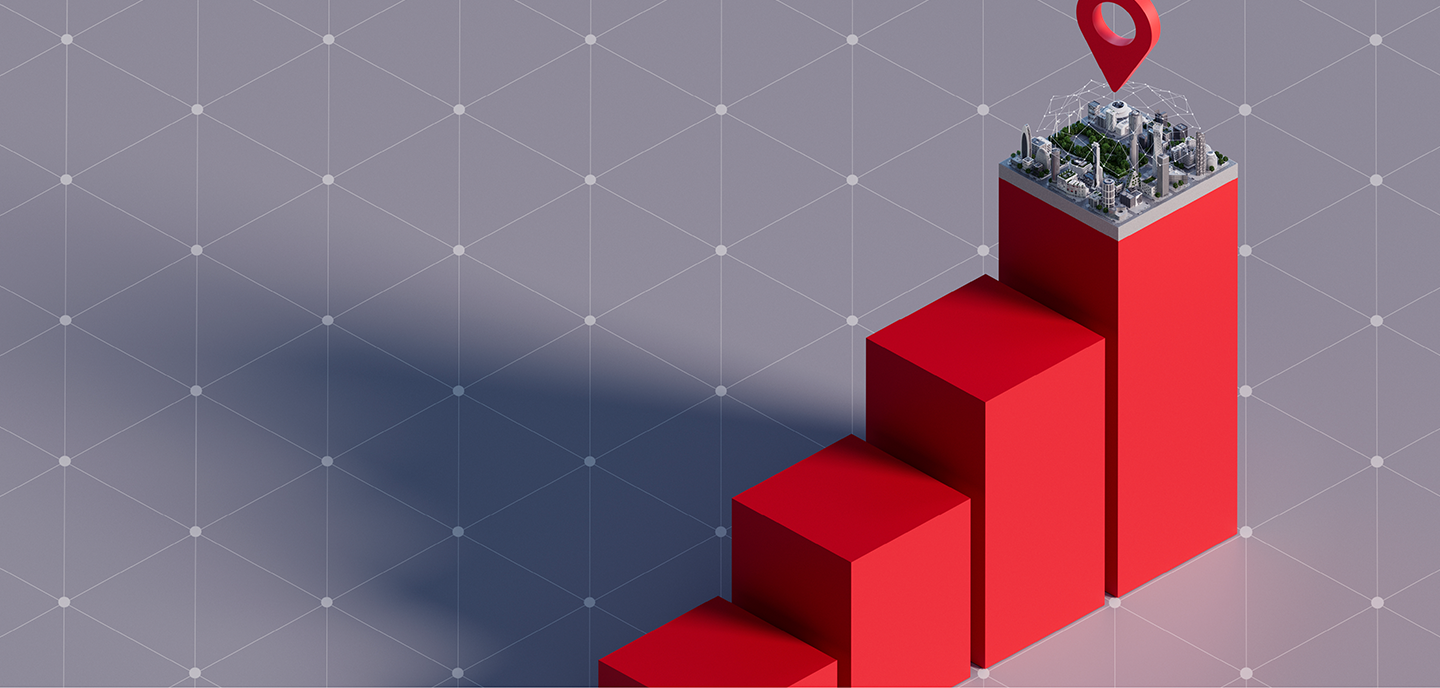 Four ascending red 3D blocks create a staircase effect against a gray grid background. The top block features a miniature cityscape with a prominent red map location marker, casting a shadow to the left. The scene symbolizes growth and urban development.