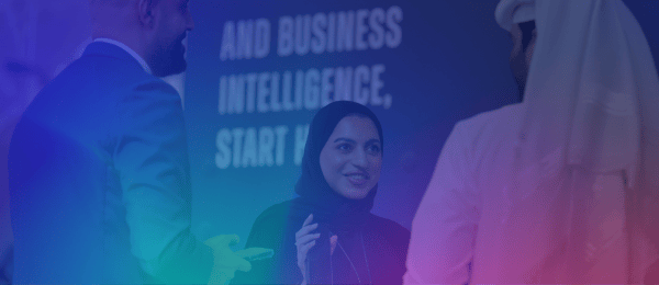 Three people, two men and a woman in a hijab, are having a conversation about scam prevention. The background shows large, blurry text reading "AND BUSINESS INTELLIGENCE, START H..." with a blue and pink gradient overlay.