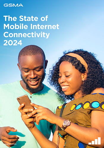 A smiling man and woman stand outdoors, looking at a mobile the woman is holding. Both appear happy and engaged. The sky is clear blue. White text reads: "The State of Mobile Internet Connectivity 2024." The GSMA logo is in the top left corner.