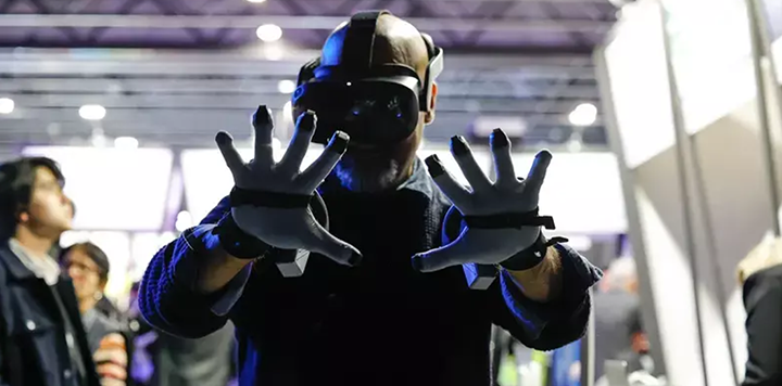 A person wearing a vr glove at an event.
