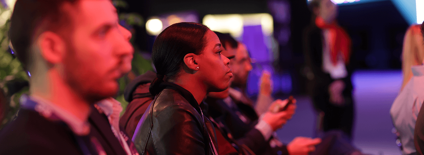 A group of people at a conference looking at their phones.