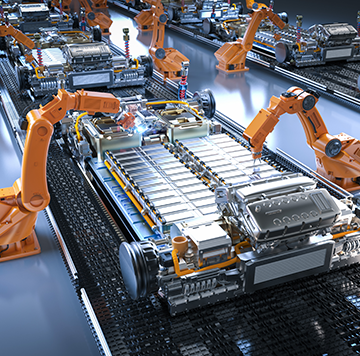 Automated robotic arms assembling electric car batteries on a production line in a modern factory.