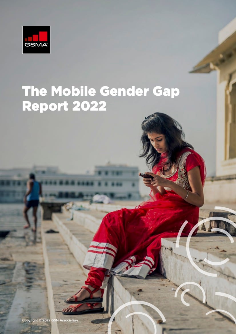 A woman in a red dress sits on steps by the water, looking at her mobile. The text reads “The Mobile Gender Gap Report 2022.” The GSMA logo is in the top left corner. Soft geometric designs appear in the lower right.