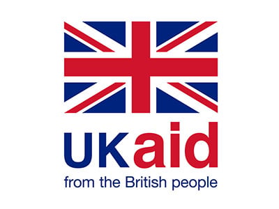 The image shows the UK aid logo, featuring the Union Flag above the words "UK aid" in large blue and red letters, with the phrase "from the British people" in smaller blue text below. The background is white.