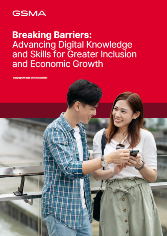 A smiling man and woman stand outdoors, both looking at a mobile phone together. Above them is a red banner with white text: “Breaking Barriers: Advancing Digital Knowledge and Skills for Greater Inclusion and Economic Growth.”.